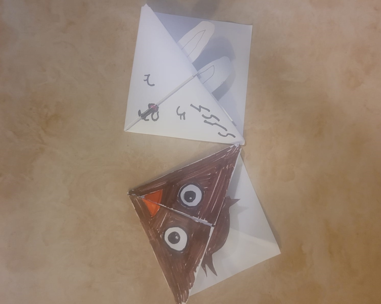 A picture of one owl origami bookmark and one rabbit origami bookmark side by side
