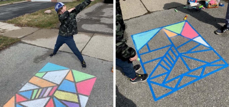A young boy stands on his driveway in front of his brightly coloured mosaic art
